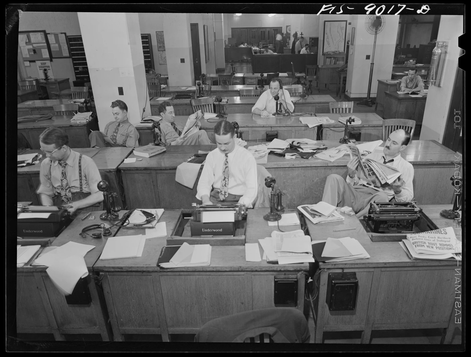 1942年9月、ニューヨーク・タイムズの編集室で、記者やリライト担当者がタイプライター、新聞、電話を前に作業する様子